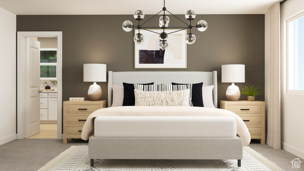 Carpeted bedroom with connected bathroom, baseboards, and a chandelier