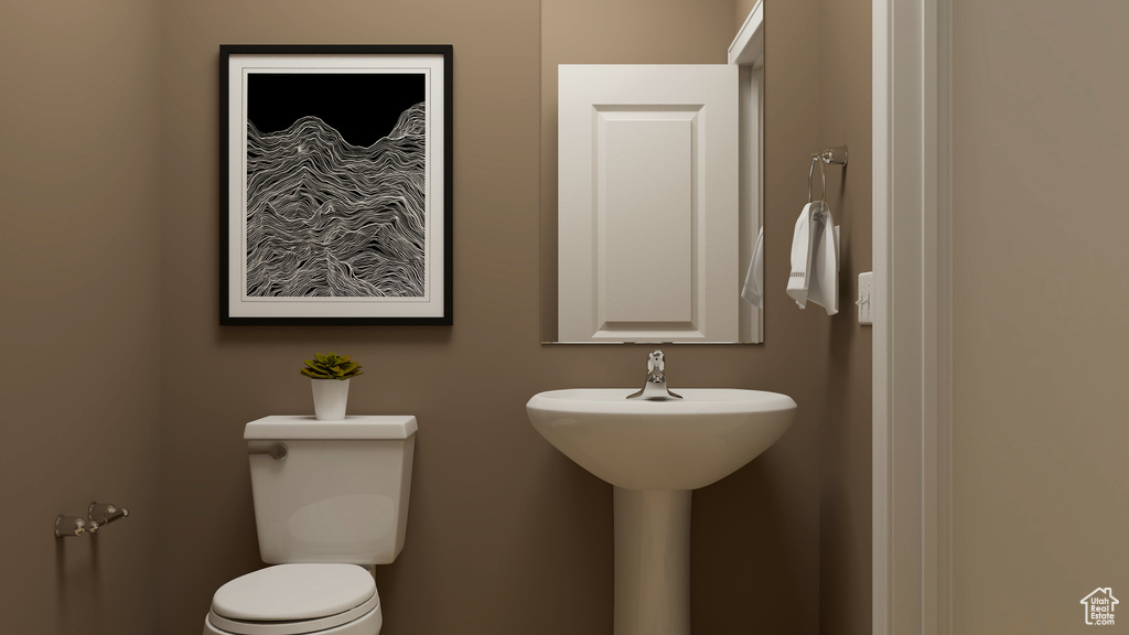 Half bathroom with toilet and a sink