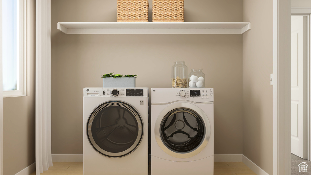 Laundry area featuring washer and clothes dryer and baseboards