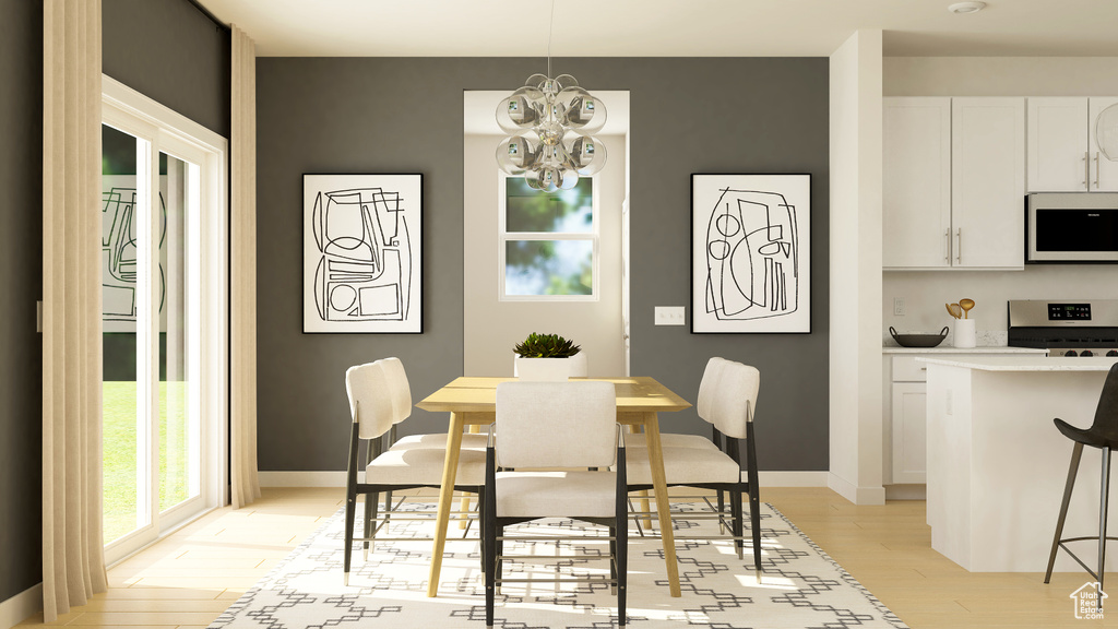 Dining area with light wood finished floors, a chandelier, and baseboards