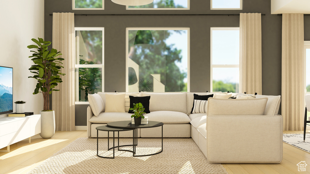 Living room with light wood-style flooring and healthy amount of natural light