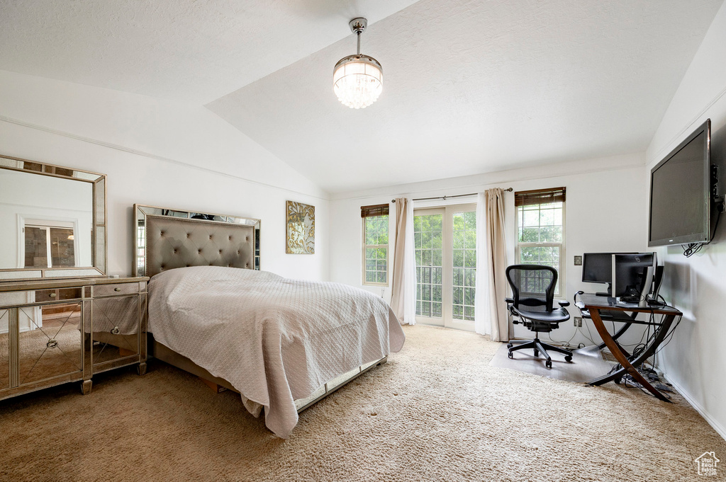 Bedroom with carpet, access to outside, vaulted ceiling, and an office area