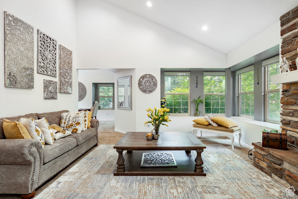 Living room featuring recessed lighting, baseboards, high vaulted ceiling, and carpet floors