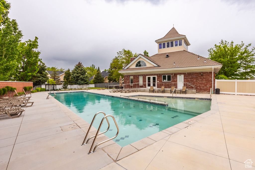View of pool with a patio area and french doors