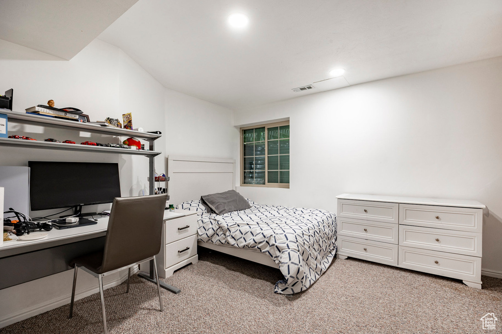 Bedroom with light colored carpet, an office area, vaulted ceiling, and recessed lighting