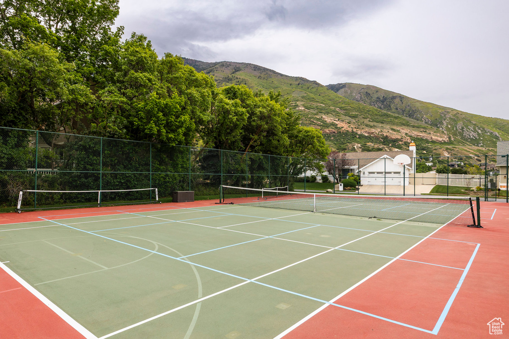View of tennis court featuring a mountain view and community basketball court