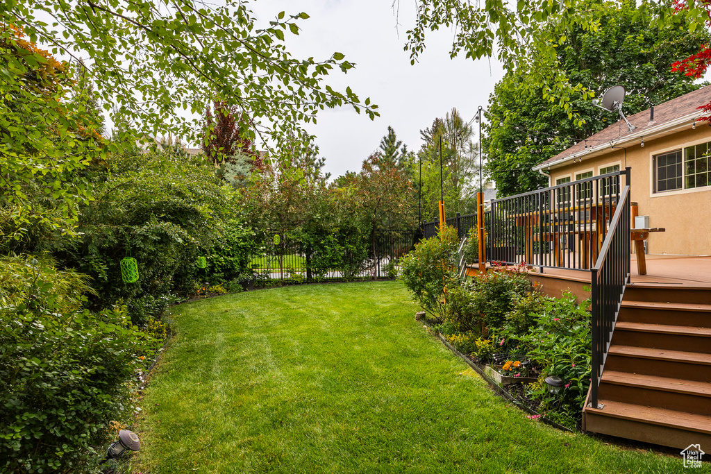 View of yard with a wooden deck