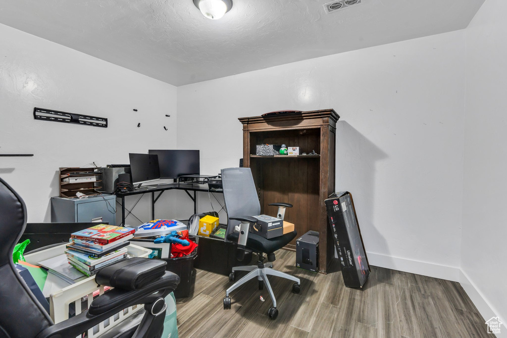 Office with wood finished floors and baseboards