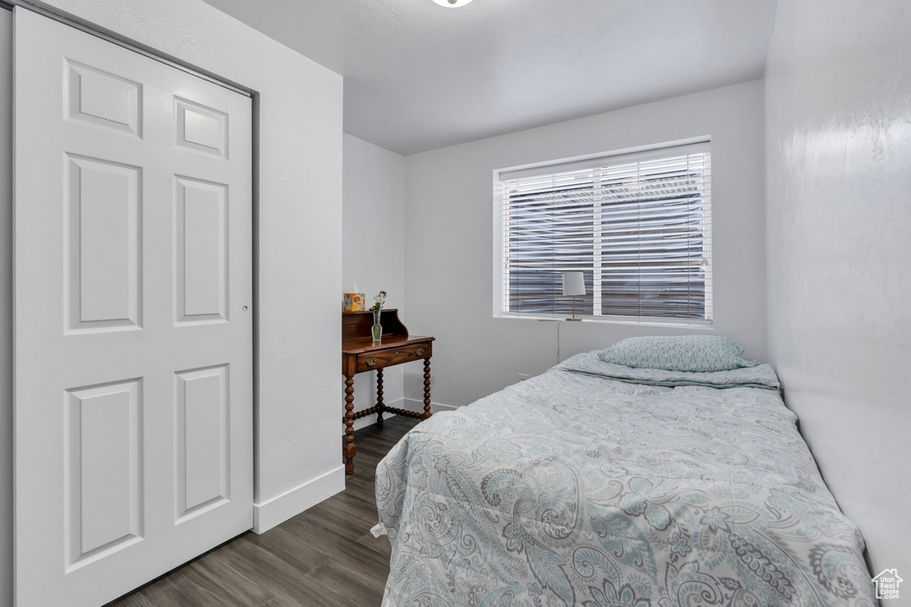 Bedroom featuring wood finished floors and baseboards