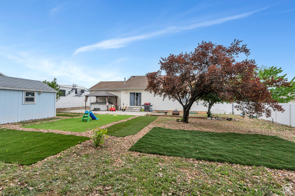 Back of house featuring a gazebo, a patio area, and an outdoor structure