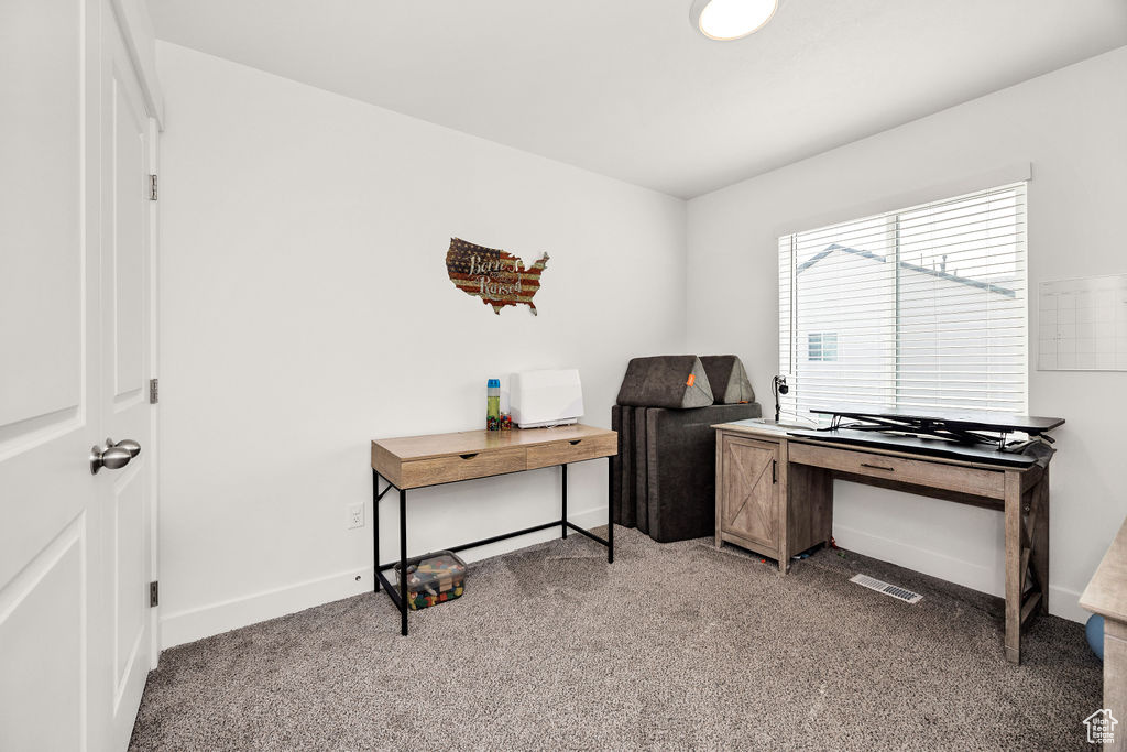 Carpeted office featuring baseboards