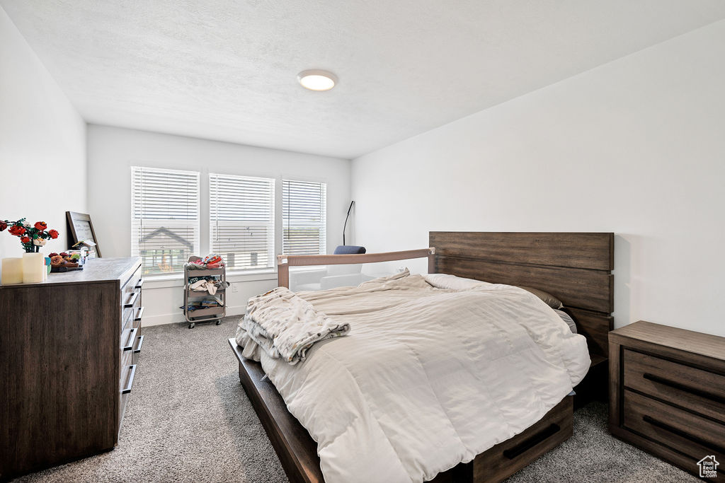 Carpeted bedroom featuring baseboards