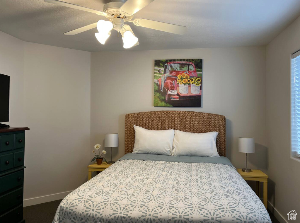 Bedroom featuring baseboards and a ceiling fan