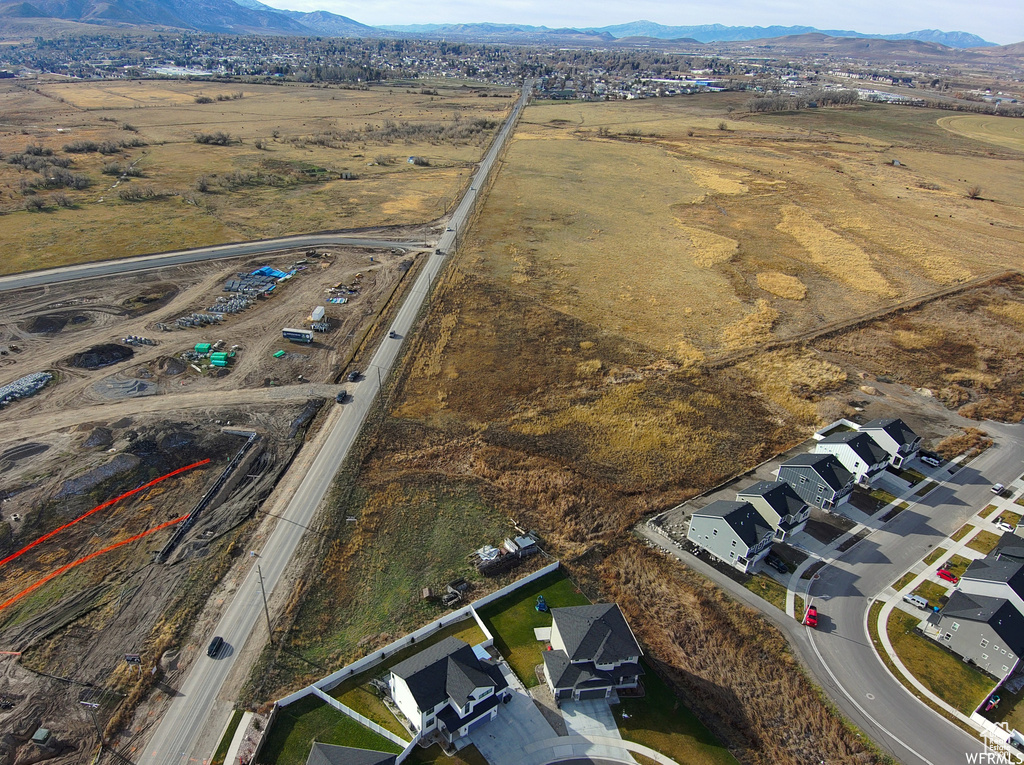 Aerial view of property's location with a mountain backdrop