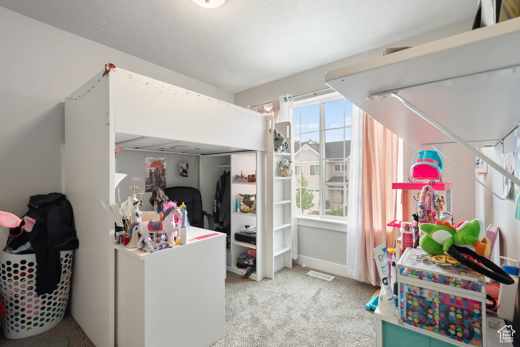 Bedroom featuring carpet and a closet