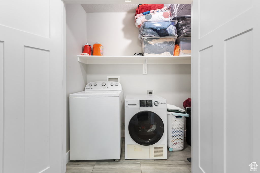 Washroom featuring washer and clothes dryer
