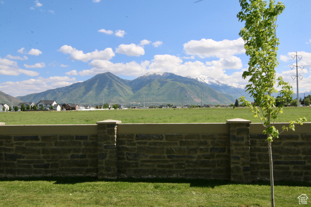 View of mountain backdrop with rural landscape