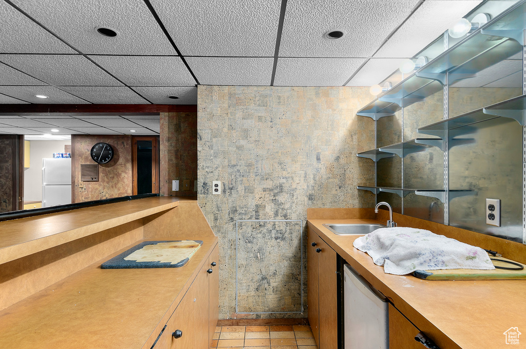 Bathroom with a paneled ceiling and vanity