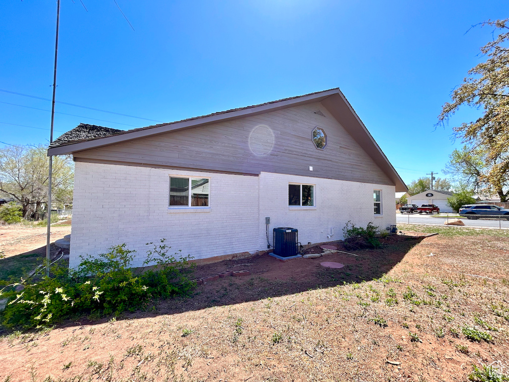 View of home's exterior featuring brick siding and central AC unit
