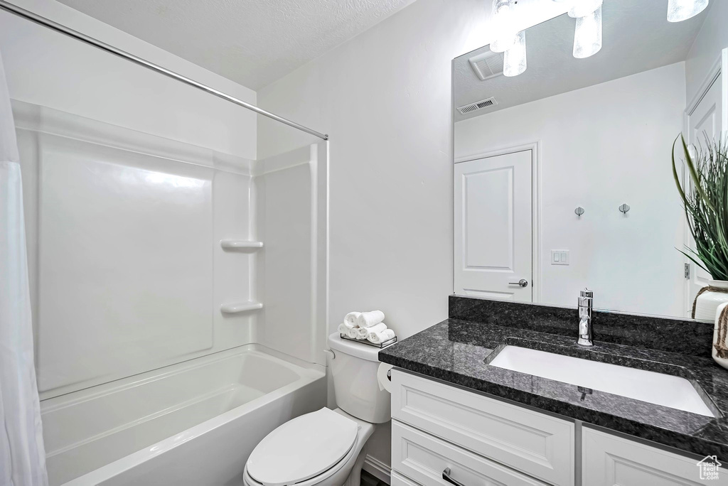 Bathroom with vanity, toilet, and shower / bath combination