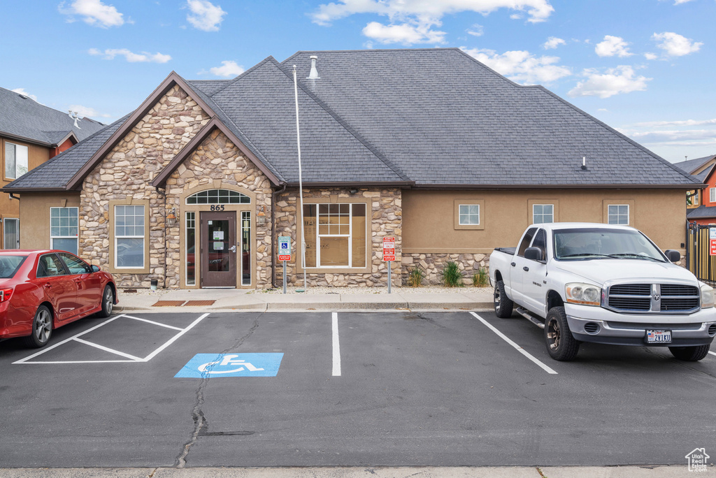 View of property with uncovered parking