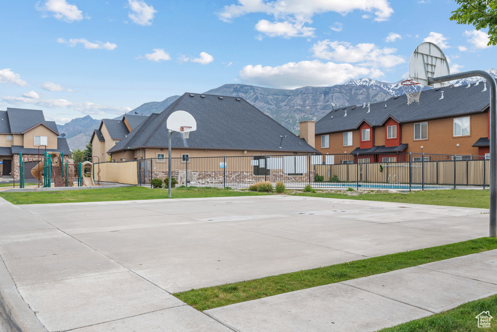 View of sport court with community basketball court, a mountain view, and a residential view