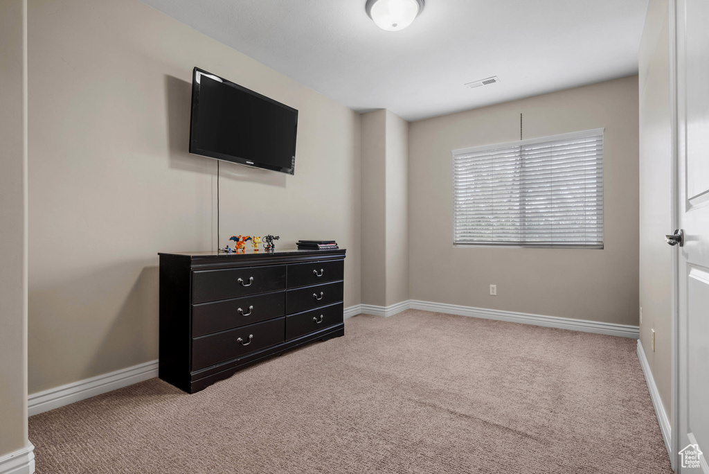 Bedroom with carpet flooring and baseboards