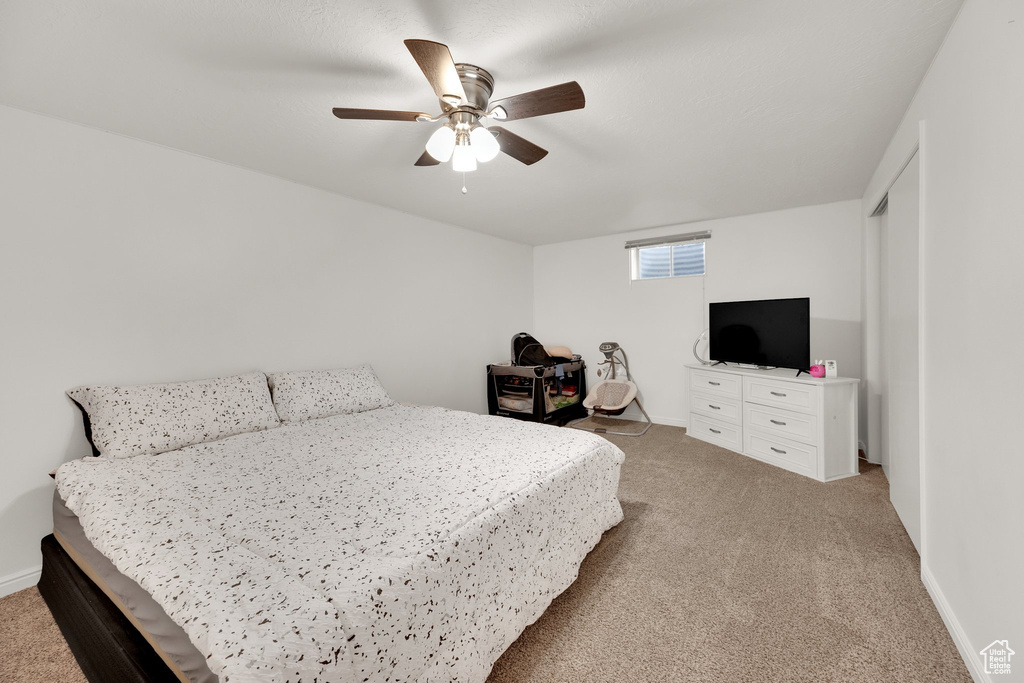 Bedroom featuring carpet, ceiling fan, and baseboards