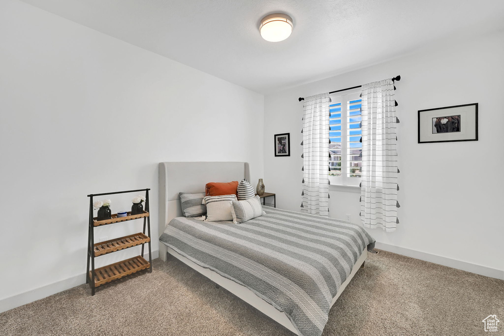 Carpeted bedroom featuring baseboards
