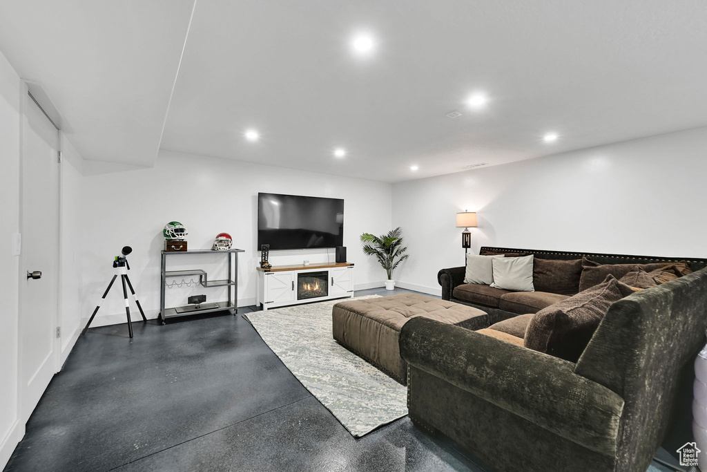Living area featuring recessed lighting, baseboards, and a glass covered fireplace