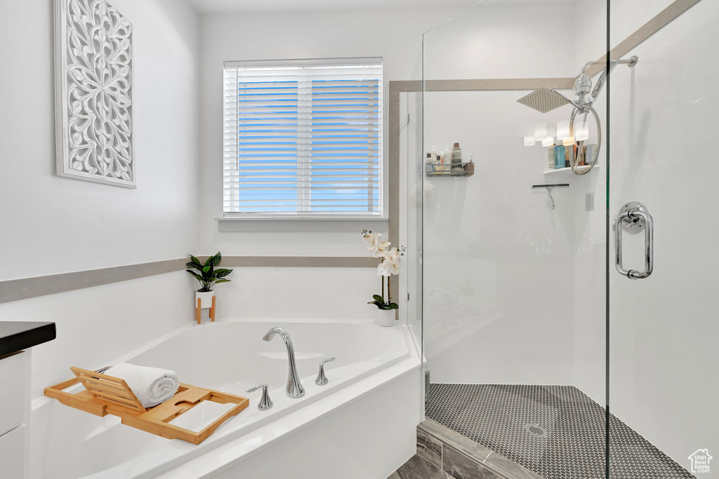 Bathroom with a shower stall and a garden tub