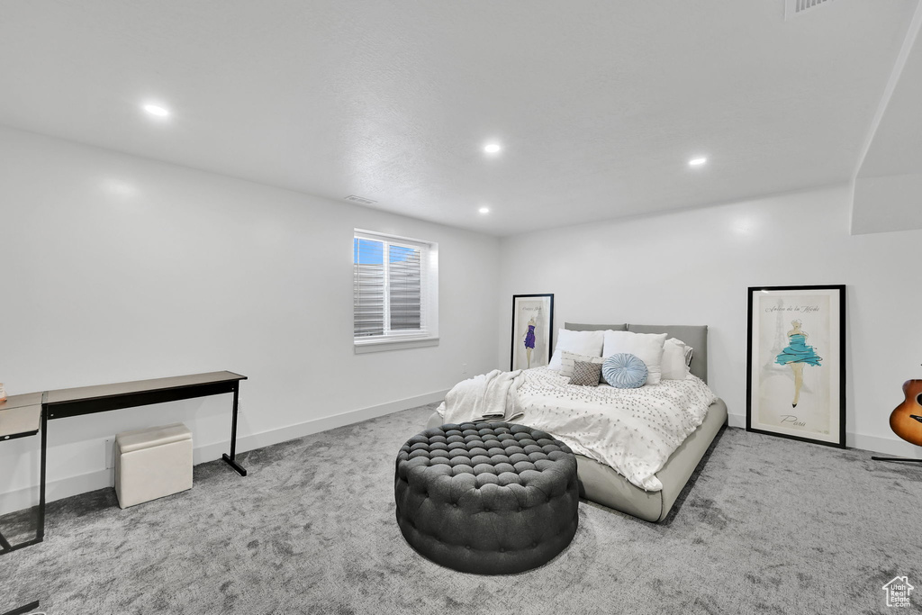 Carpeted bedroom with recessed lighting and baseboards