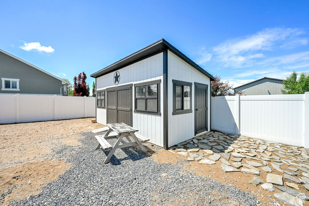 View of outbuilding with a fenced backyard