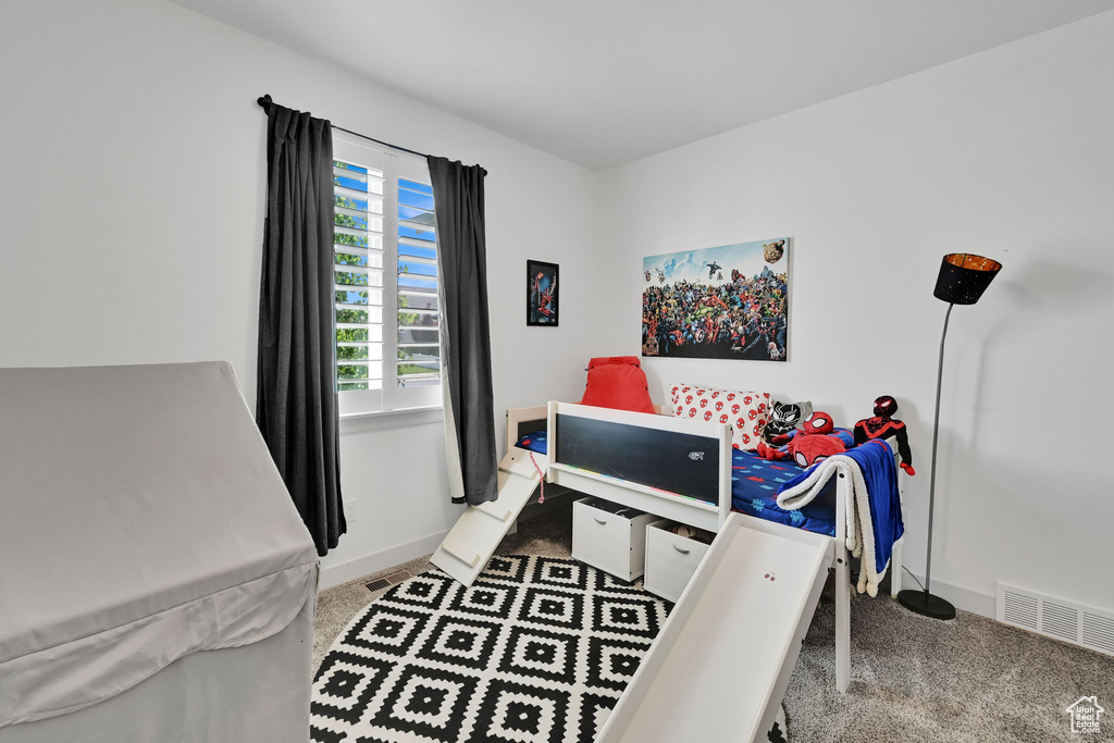 Bedroom featuring carpet flooring and baseboards