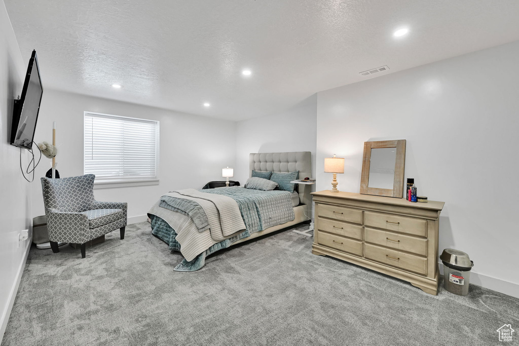 Bedroom with recessed lighting, carpet floors, baseboards, and a textured ceiling