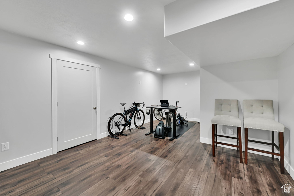 Workout room with recessed lighting, dark wood-style floors, and baseboards