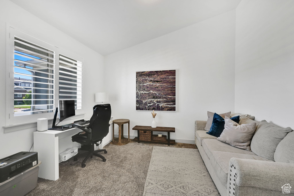 Office area with carpet flooring and vaulted ceiling