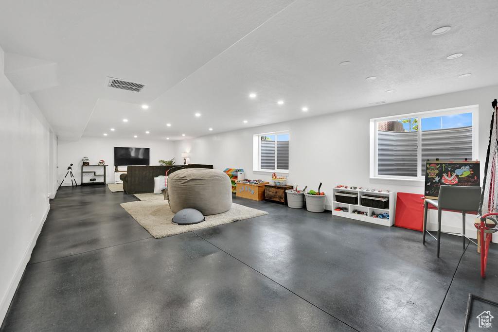 Interior space with recessed lighting, finished concrete floors, and baseboards