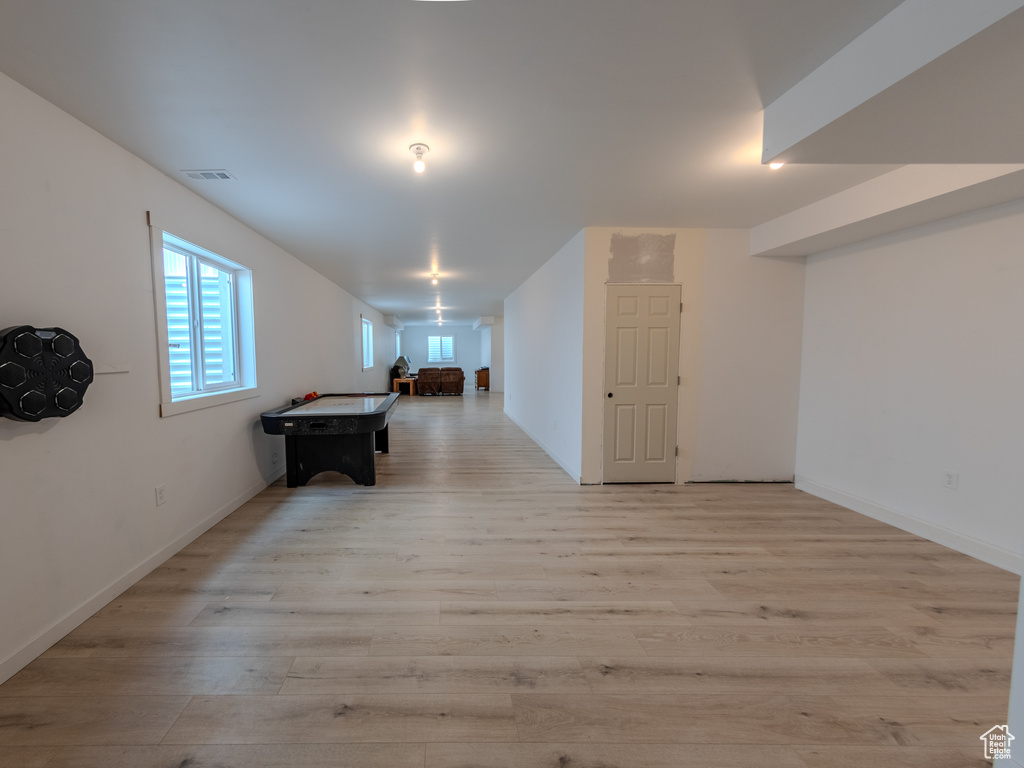 Rec room featuring light wood-type flooring and baseboards
