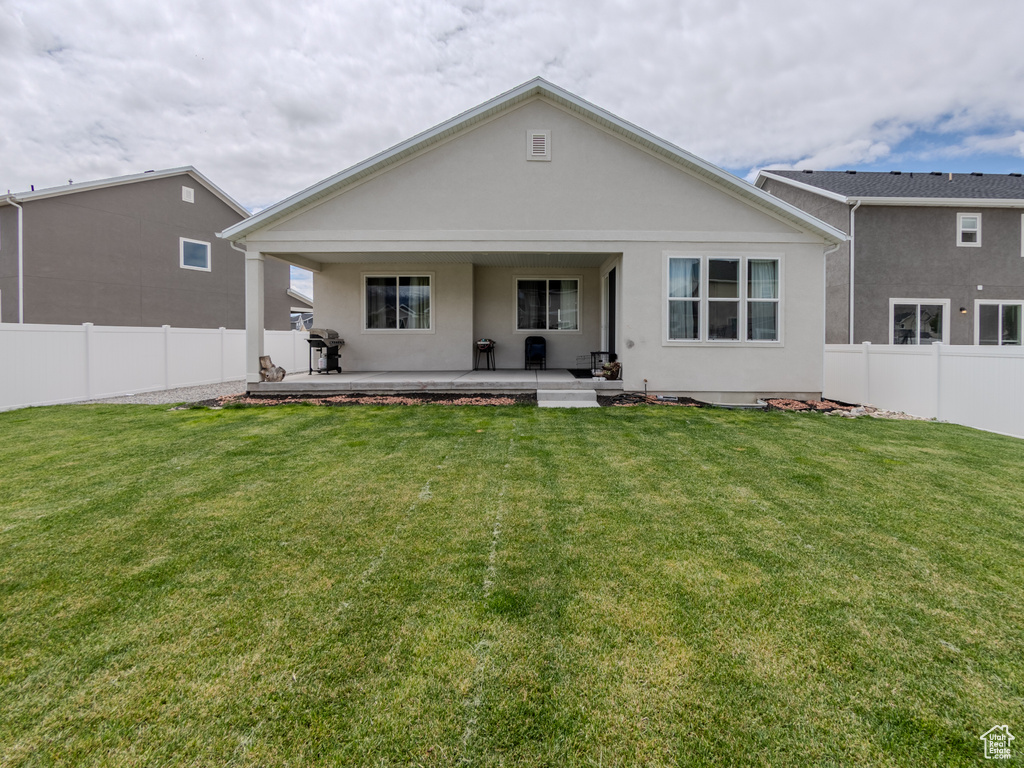 Rear view of property featuring stucco siding and a patio