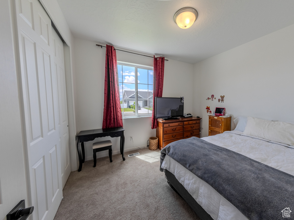 Bedroom featuring a closet, carpet, and baseboards