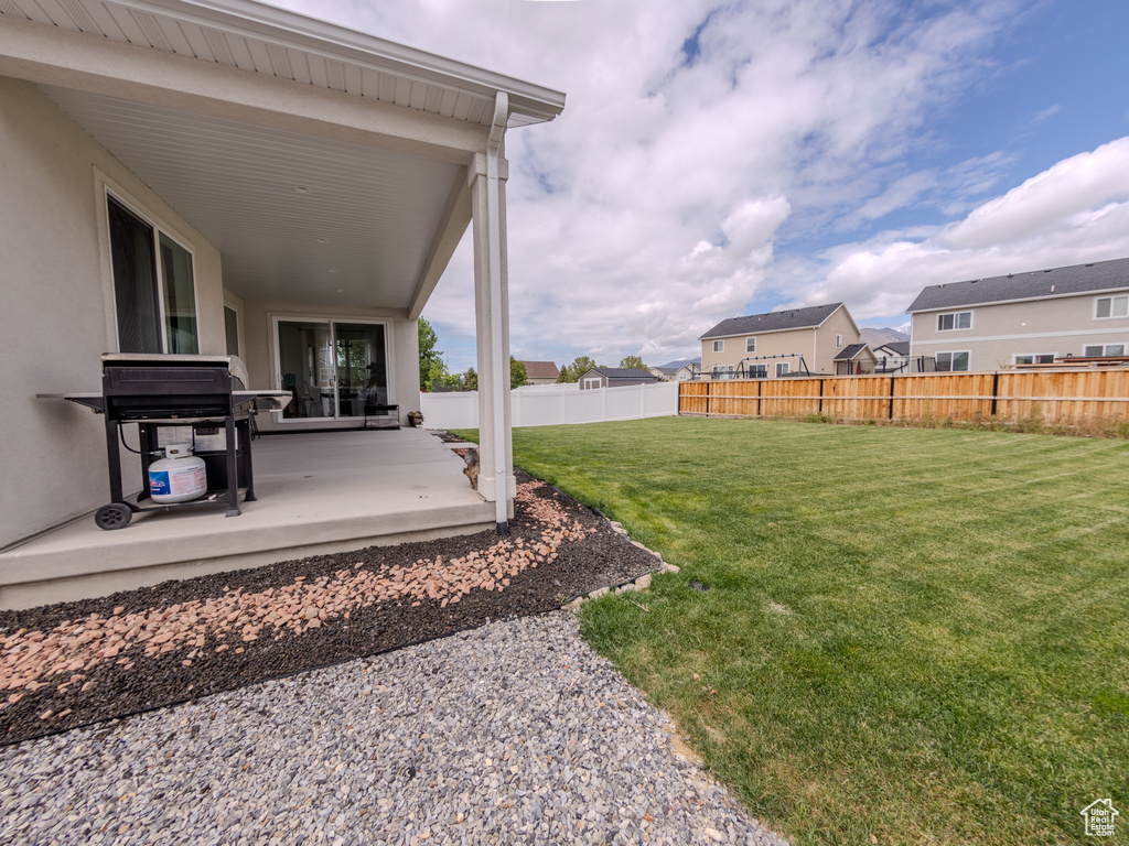 View of yard featuring a patio and a residential view