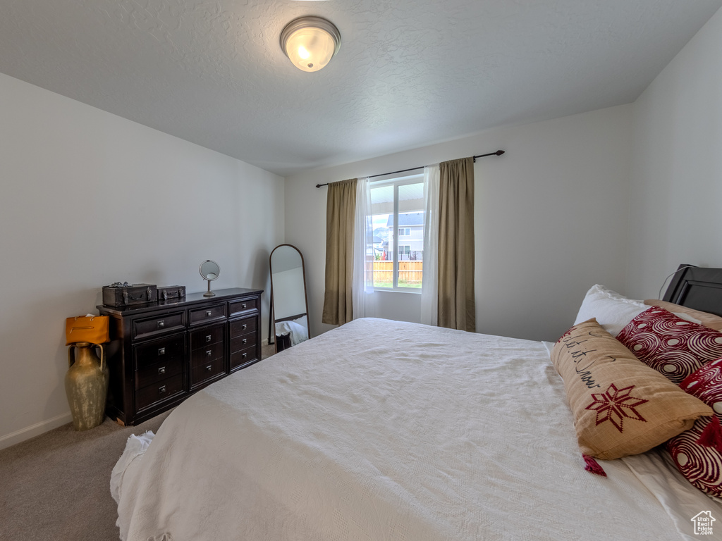 Carpeted bedroom featuring baseboards