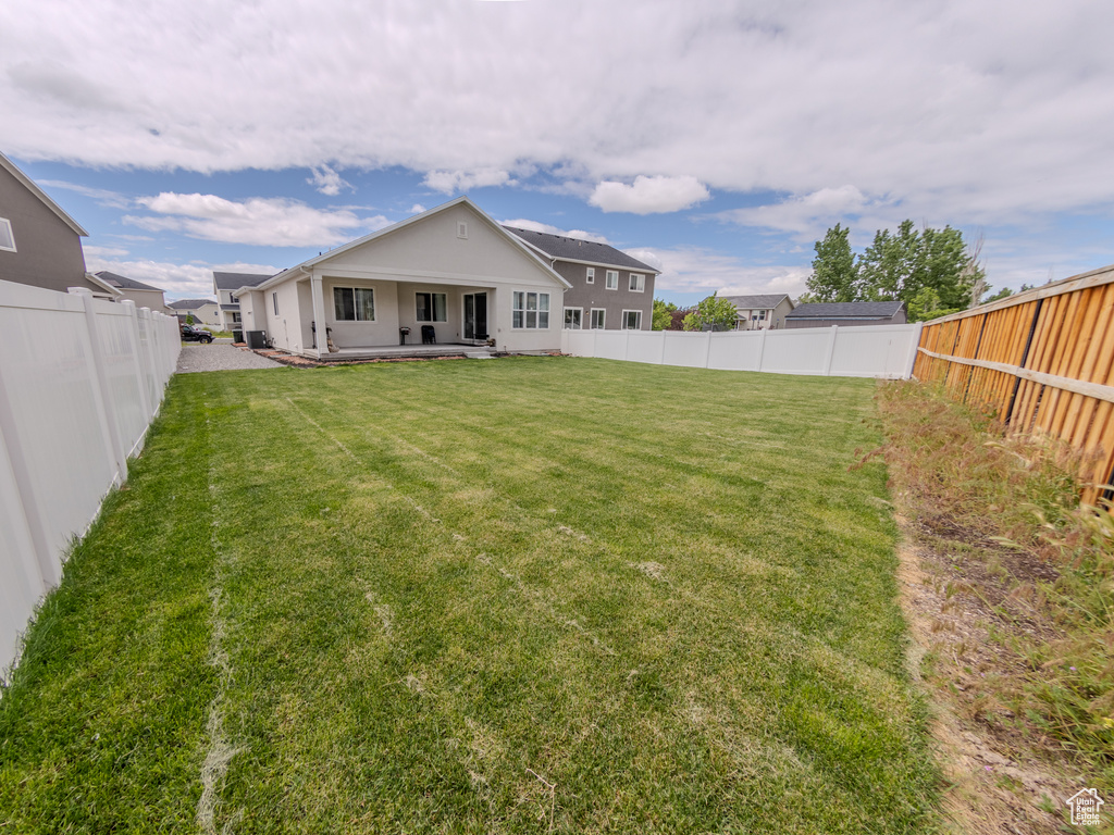 Back of property with a patio area and stucco siding