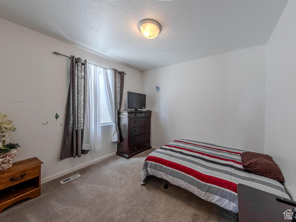 Carpeted bedroom with baseboards