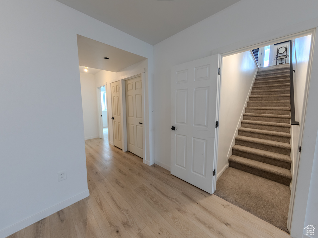 Staircase featuring wood finished floors and baseboards