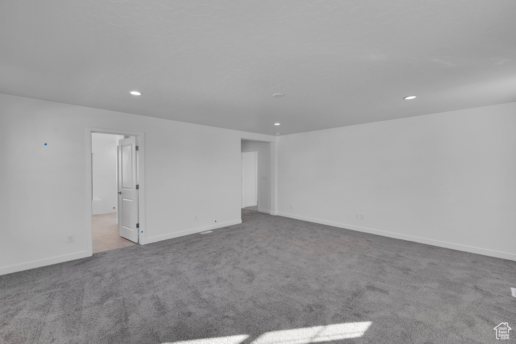 Carpeted spare room with recessed lighting and baseboards