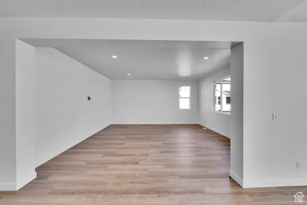 Empty room with light wood-type flooring, recessed lighting, and baseboards