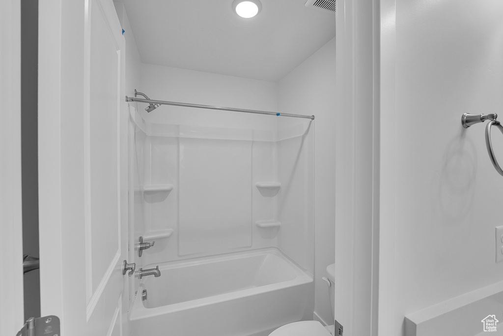 Bathroom featuring toilet and bathtub / shower combination