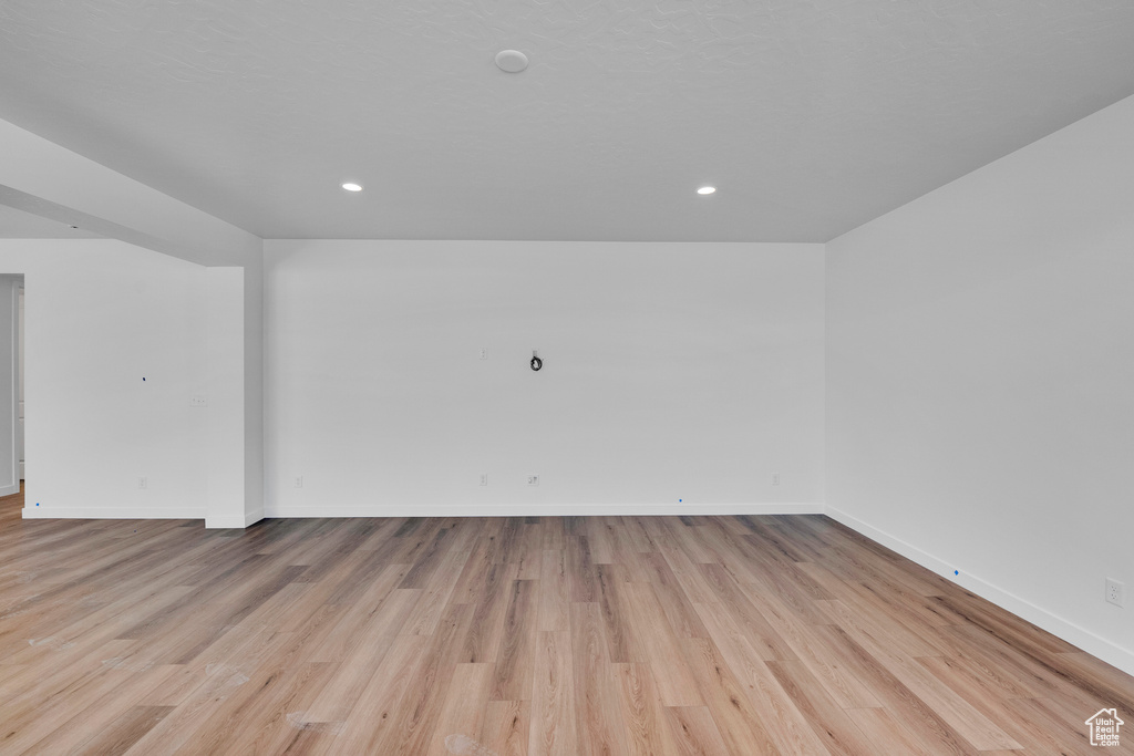 Unfurnished room with baseboards, light wood-style floors, and recessed lighting